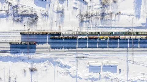 Winter top view of the train passing through the settlement Stock Photos