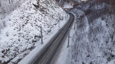 Winter tourist train between hills drone follow Trans-Siberian railway Video stock 88464559