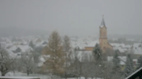Winter Town Under Snow Snowfall Church Blurred background Germany Stock Footage 104116505