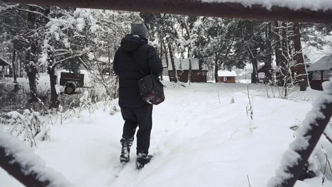 Winter tracking shot of hiker walking from the camera in the deep snow. He is 스톡 동영상 101117780