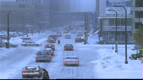 Winter traffic downtown snow falling Video stock 144451682