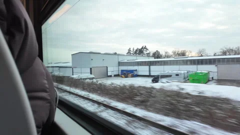 Winter Train Ride Capturing Derelict Industrial Building Amid Snowy Bare Trees Stock Footage 327059405