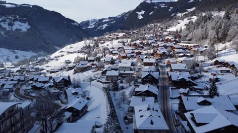 Winter Train Voyage: 4K Drone Follows Train in Snowy Grindelwald, Switzerland Stock Footage 246609022
