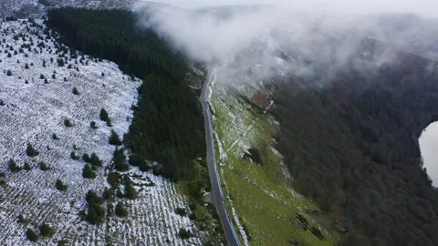 Winter Tranquility: Aerial View of an Empty Wicklow Mountain Road Split by Stock Footage 258635871