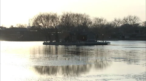 Winter trees reflection, icy lake, China Stock Footage 56649596
