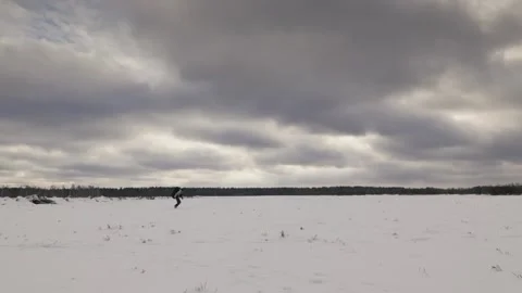 Winter Trek: Adventurous Run Across Snowy Fields Stock Footage 317609281
