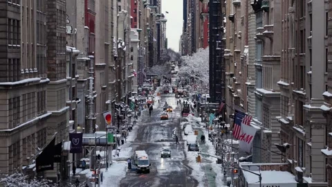 Winter view of busy New York City street with snow covered sidewalks, traffic Stock Footage 332139541