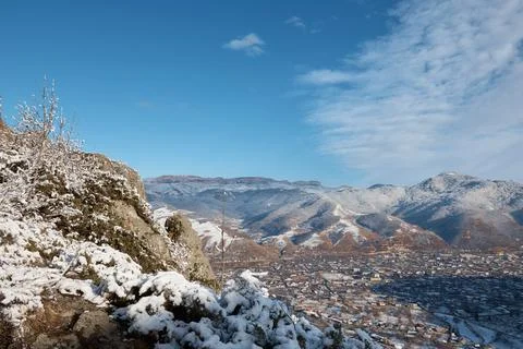 Winter, view from mountain to small town, snow rocks and stones, village in Stock Photos