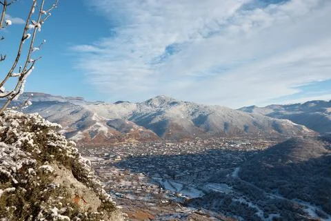 Winter, view from mountain to small town, snow rocks and stones, village in Stock Photos