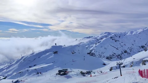 Winter view of the mountains with clouds below on the ski resort Stock Footage 230178171