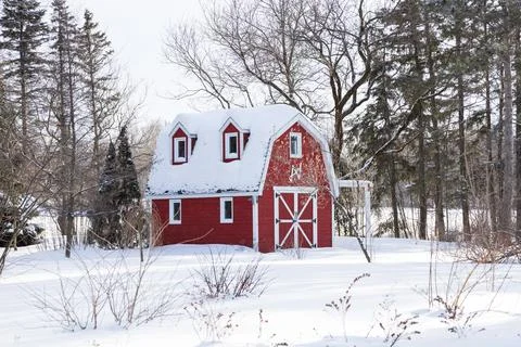 Winter view of small red barn in field Stock Photos
