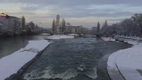 Winter view of the snowy Isar river in Munich, Germany, taken from Stock Footage 326645985