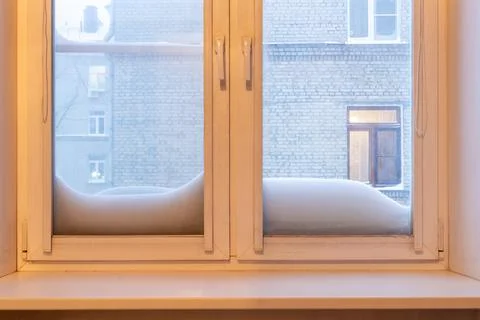A winter view through double pane windows with snowdrifts outside Stock Photos