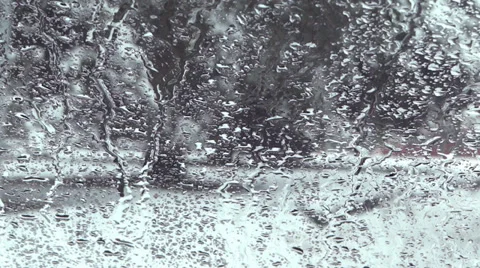 Winter Village - 14 - Street, Traffic and Trees In Snow Through Wet Window Stock Footage