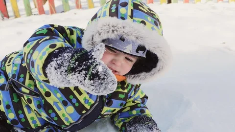 Winter walk. Boy playing with snow Stock Footage 85617074