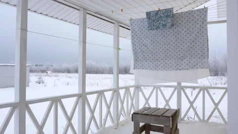 Winter. Washed clothes are dried on the veranda of a rural house Stock-Footage 145146195