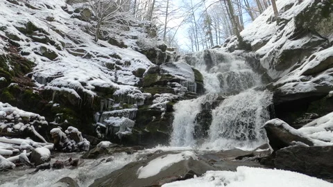Winter waterfall in the Carpathians, static plan. Water beats against stones Stock Footage 177989856