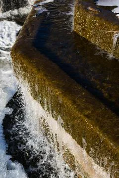 Winter waterfall. Diagonal lines. Weak waterfall water pressure Stock Photos