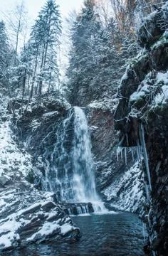 Winter waterfall in forest Stock Photos