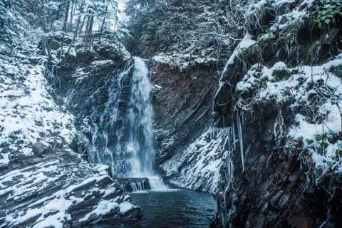 Winter waterfall in forest Stock Photos