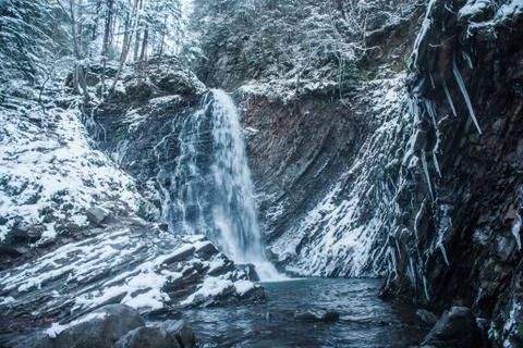 Winter waterfall in forest Stock Photos