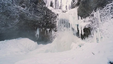 Winter Waterfall subtle pan left with person taking it in Stock Footage 71240125
