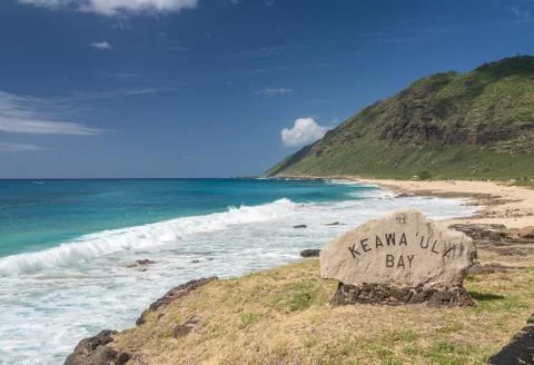 Winter waves crash on the broad sandy shore at Kaewaula beach on Oahu Stock Photos