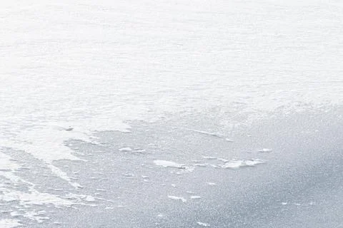 Winter white texture drone shot of ice and snow on a frozen lake Stock Photos
