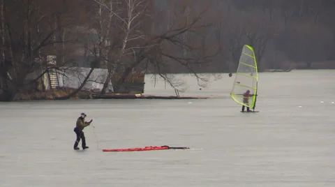 Winter Wind Surfer And Kiter on the frozen lake surface Stock Footage 36541853