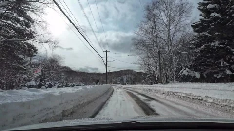 Winter winding road driving warning signs snowy mountain Japan 스톡 동영상 333204930
