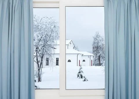 Winter window view of the building window view of white stone house in a s... Fotos de archivo