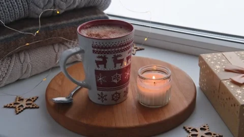 Winter windowsill still life. Red ceramic cup of hot coffee on window sill Vídeo Stock 257087331