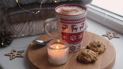 Winter windowsill still life. Red ceramic cup of hot coffee on window sill Vídeo Stock 257089814