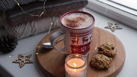 Winter windowsill still life. Red ceramic cup of hot coffee on window sill Vídeo Stock 257090255