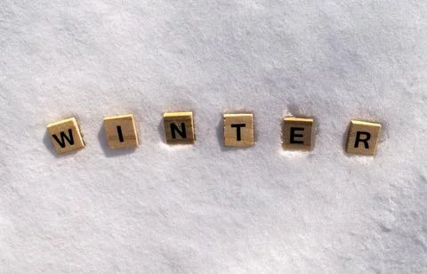 Winter word on white clean snow. Winter is written on a snow with wooden letters Stock Photos