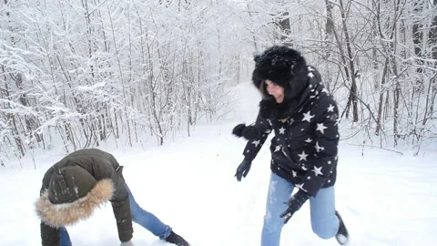 Winter young couple having fun playing in snow outdoors. Winter and Christmas Stock Footage 100821343