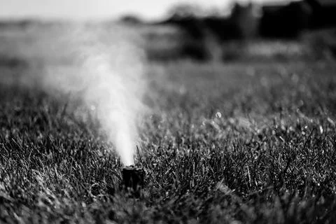 Winterizing a irrigation sprinkler system by blowing pressurized air through to Stock Photos