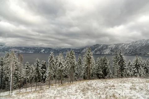 Wintery clouds over the lake. Stock Photos