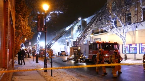 Wintery scene of a structure fire creating a little bit of smoke in the night Vidéo 104226396
