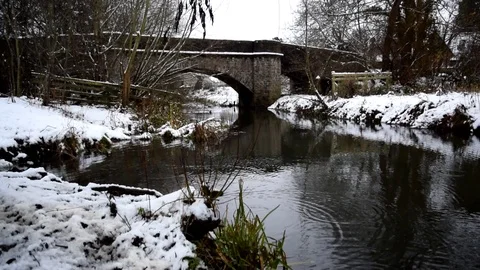 Wintry Scene, Bridge Over Snowy Riverbank Stock Footage 99657856