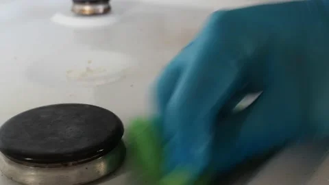 Wipe the dirty plate with a sponge. we spray it with cleaning agent Stock Footage 144474692