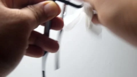 Wipe the glasses with cleaning fluid Stock Footage 324452395