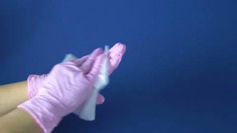Wipe gloved hands with a damp cloth 4K Vídeo Stock 126805893