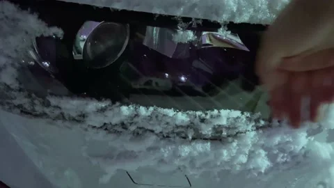 Wipe headlights from the snow Stock Footage 166474326
