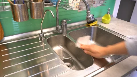 Wipe the kitchen sink and countertops with a paper towel from drops of water, Stock Footage 120615732