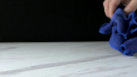 Wipe the kitchen top with a blue microfiber Stock Footage 106402434