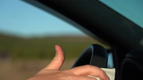 Wipe the steering wheel of the car with a damp cloth. Stock Footage 156533157
