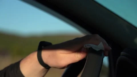 Wipe the steering wheel of the car with a damp cloth. Stock Footage 157500680