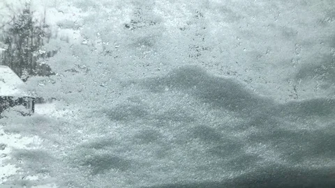 Wiper blades clearing snow from windshield in wither Stock-Footage 107278081