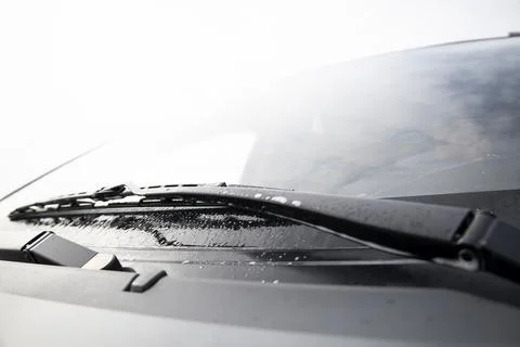 Wiper blades work when cleaning a car's windshield. Stock Photos